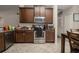 The kitchen features stainless steel appliances, wooden cabinets, and lots of natural light at 1619 Prairie Blossom Dr, Lakeland, FL 33810