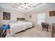 Comfortable main bedroom featuring a tray ceiling, ceiling fan, and plenty of room for a work-from-home setup at 1619 Prairie Blossom Dr, Lakeland, FL 33810
