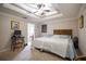 Main bedroom with tray ceiling, ceiling fan, and an en-suite bathroom; designed for comfort and relaxation at 1619 Prairie Blossom Dr, Lakeland, FL 33810