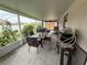 Enclosed patio with outdoor dining set and view of the green yard, perfect for entertaining at 1619 Prairie Blossom Dr, Lakeland, FL 33810
