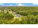 Aerial view showing a well-maintained home surrounded by lush, mature trees and greenery at 1896 12Th St, Orange City, FL 32763