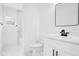 Bathroom with marble tile shower, modern vanity, and square mirror at 1896 12Th St, Orange City, FL 32763