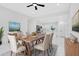 Bright dining room offers an open floor plan with modern table set and beautiful decor at 1896 12Th St, Orange City, FL 32763