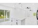 Bright open kitchen features an island, sliding doors and white cabinets at 1896 12Th St, Orange City, FL 32763