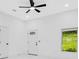 Bright living room featuring a ceiling fan, sleek white walls, and a window at 1896 12Th St, Orange City, FL 32763
