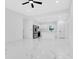 Bright living room features an open floorplan with sleek marble floors and contemporary design at 1896 12Th St, Orange City, FL 32763
