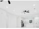 Bright living room and modern kitchen featuring sleek white walls and a ceiling fan at 1896 12Th St, Orange City, FL 32763