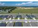 An aerial view shows the home nestled in a well-planned community, near a tranquil lake and open green spaces at 1029 Mattie Pointe Way, Auburndale, FL 33823