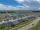 From above, the house sits in a large neighborhood, near roadways and a small pond at 1029 Mattie Pointe Way, Auburndale, FL 33823