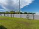 A manicured backyard is enclosed by a privacy fence and features lush green grass at 1029 Mattie Pointe Way, Auburndale, FL 33823