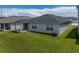 The backyard has a covered patio, a well-maintained lawn, and an air conditioning unit at 1029 Mattie Pointe Way, Auburndale, FL 33823