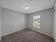 Bedroom with carpeted floors, neutral paint, and a window offering natural light at 1029 Mattie Pointe Way, Auburndale, FL 33823