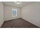 A carpeted bedroom features a window with blinds and neutral-colored walls at 1029 Mattie Pointe Way, Auburndale, FL 33823