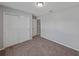Bedroom featuring neutral paint, carpeted floors, a ceiling light, and a double door closet at 1029 Mattie Pointe Way, Auburndale, FL 33823