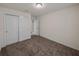 A carpeted bedroom features a closet with sliding doors and an open doorway at 1029 Mattie Pointe Way, Auburndale, FL 33823