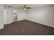 Cozy bedroom with a ceiling fan, carpet, and an open doorway to the en-suite bathroom at 1029 Mattie Pointe Way, Auburndale, FL 33823