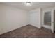 A carpeted bedroom features a closet with sliding doors and an open doorway at 1029 Mattie Pointe Way, Auburndale, FL 33823
