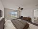 Cozy main bedroom with a ceiling fan, large window, and modern decor at 1029 Mattie Pointe Way, Auburndale, FL 33823
