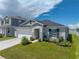 Charming single-story home with well-manicured lawn and a two car garage at 1029 Mattie Pointe Way, Auburndale, FL 33823