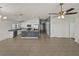 Spacious kitchen with stainless steel appliances, island with decorative stone, and tiled floors at 1029 Mattie Pointe Way, Auburndale, FL 33823