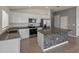 Kitchen featuring stainless steel appliances, white cabinetry, granite countertops, and a tiled island at 1029 Mattie Pointe Way, Auburndale, FL 33823