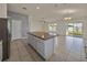 Spacious kitchen with an island, stainless steel refrigerator and tile floors throughout the house at 1029 Mattie Pointe Way, Auburndale, FL 33823