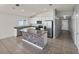 Open kitchen features granite countertops, stainless steel appliances, and a stylish center island with tile accents at 1029 Mattie Pointe Way, Auburndale, FL 33823