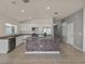 Bright kitchen with granite countertops, stainless steel appliances and tile flooring, featuring an island with seating at 1029 Mattie Pointe Way, Auburndale, FL 33823