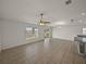 Open concept living space features large window, tile flooring, and opens to kitchen area at 1029 Mattie Pointe Way, Auburndale, FL 33823