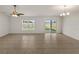 Open living room with tile flooring, ceiling fan, and sliding glass door leading to the backyard at 1029 Mattie Pointe Way, Auburndale, FL 33823