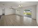 Bright living room featuring tile floors, ceiling fan, and sliding glass doors leading to the outside at 1029 Mattie Pointe Way, Auburndale, FL 33823