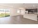 Bright open-concept living room with sliding glass doors and adjacent kitchen at 2429 Leeds St, Haines City, FL 33844