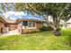 Brick house featuring a spacious backyard with mature landscaping and a cozy seating area at 480 Nighthawk Dr, Lakeland, FL 33813