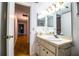 Tiled bathroom with vanity mirror, sconce lighting and hallway view at 480 Nighthawk Dr, Lakeland, FL 33813