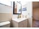 Well-lit bathroom featuring a single vanity with storage, tiled walls, and mirror at 480 Nighthawk Dr, Lakeland, FL 33813