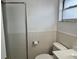 Tiled bathroom featuring a shower with glass doors and a window for natural light at 480 Nighthawk Dr, Lakeland, FL 33813