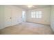Bright bedroom with neutral carpeting, plantation shutters and ensuite bathroom at 480 Nighthawk Dr, Lakeland, FL 33813