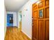 Well lit foyer with wood floors and decorative front door at 480 Nighthawk Dr, Lakeland, FL 33813