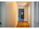 Hallway with wood flooring, closet and view into another room at 480 Nighthawk Dr, Lakeland, FL 33813