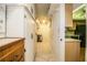 Hallway with storage leading to a kitchen with white cabinets and countertops at 480 Nighthawk Dr, Lakeland, FL 33813