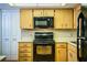 Well-maintained kitchen with wooden cabinets, black appliances and white countertops at 480 Nighthawk Dr, Lakeland, FL 33813