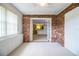 Inviting living room with exposed brick walls and view into the kitchen at 480 Nighthawk Dr, Lakeland, FL 33813