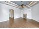 Open living room with hardwood floors, custom fireplace, built-in shelving, and plenty of natural light at 6414 Highlands In The Woods St, Lakeland, FL 33813