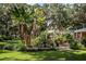 Inviting backyard oasis featuring a pergola-covered patio surrounded by lush landscaping at 7525 Catherine Dr, Lakeland, FL 33810