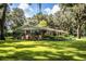 Charming one-story brick home featuring a spacious front yard and mature trees at 7525 Catherine Dr, Lakeland, FL 33810