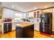 Kitchen boasts white cabinets, stainless steel appliances, and hardwood floors at 7525 Catherine Dr, Lakeland, FL 33810