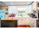 Bright kitchen with white cabinets, island, and hardwood floors at 7525 Catherine Dr, Lakeland, FL 33810