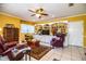 Bright living room featuring built-in shelving, comfortable armchairs, and a large TV at 7525 Catherine Dr, Lakeland, FL 33810