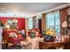 Elegant living room with antique furniture and floral arrangements at 7525 Catherine Dr, Lakeland, FL 33810