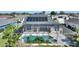 Aerial view of house with solar panels, pool, and screened enclosure at 206 Clovis Pass, Winter Haven, FL 33880